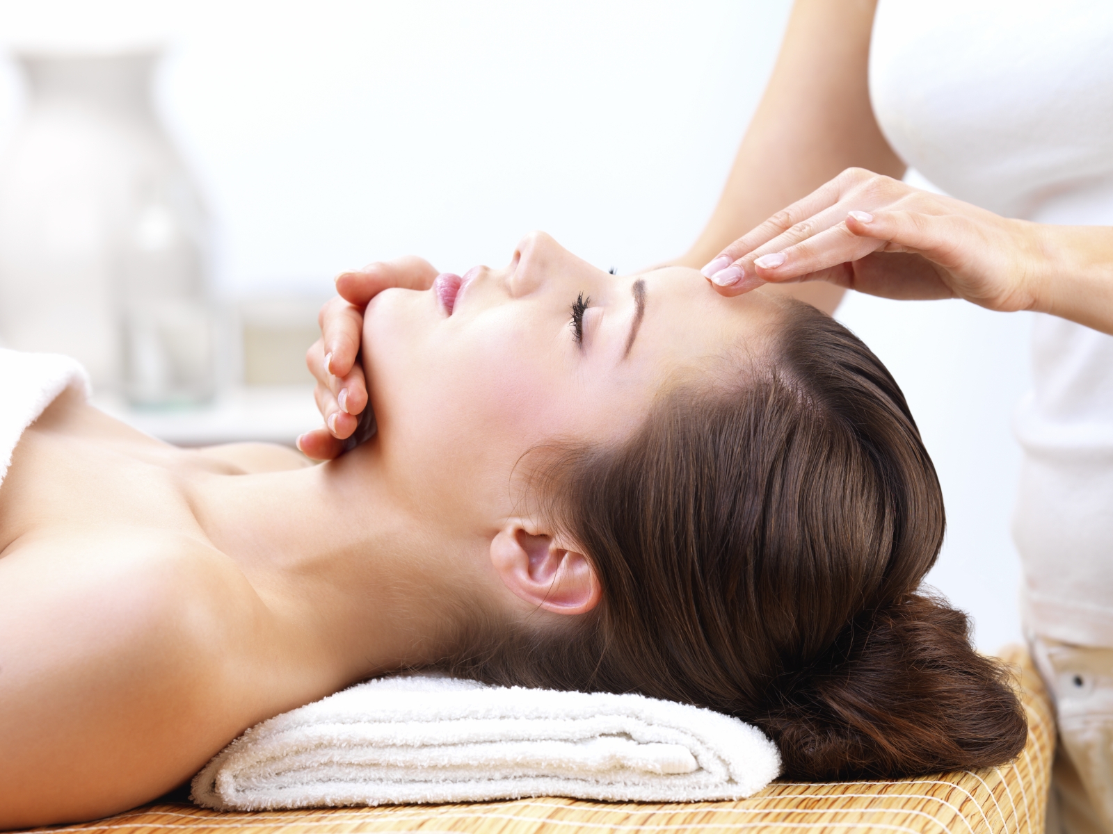 Young woman receiving facial massage Cranial Sacral Therapy